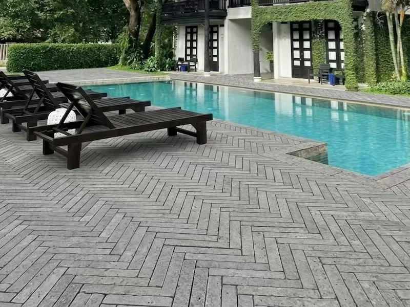 Grey Marble Herringbone Mosaic shown in a supplied poolside application reference with grey herringbone paving