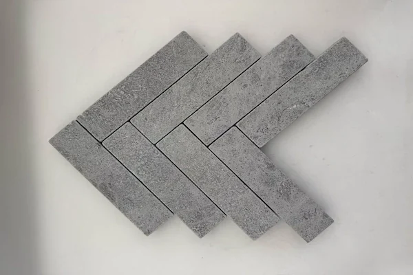 Grey Marble Herringbone Mosaic stone pieces shown in a supplied herringbone module review image