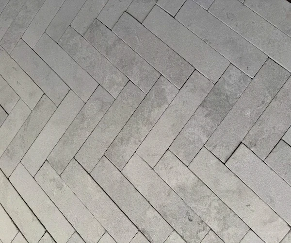 Grey Marble Herringbone Mosaic sheets shown in a supplied factory dry-lay reference image