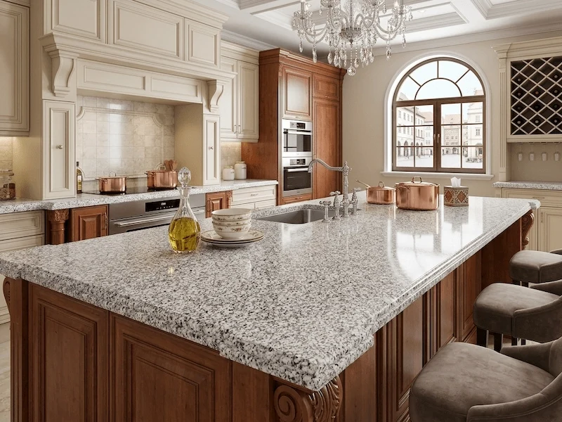 Light Grey Granite Kitchen Top in a supplied kitchen application image, showing a light-grey granite field with granular white and charcoal mineral detail
