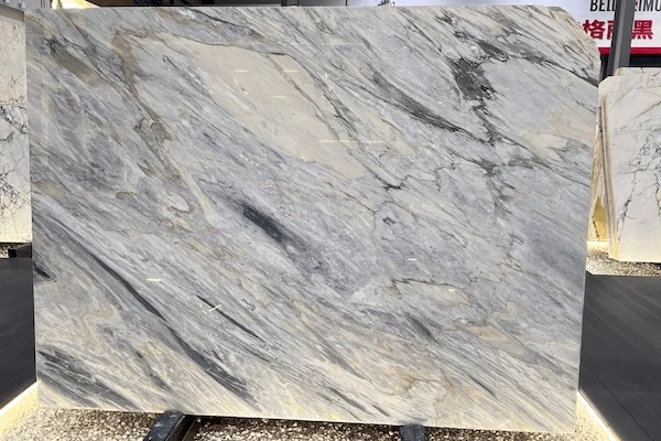Polished Manhattan Marble slab surface with cool grey background and graphite linear movement