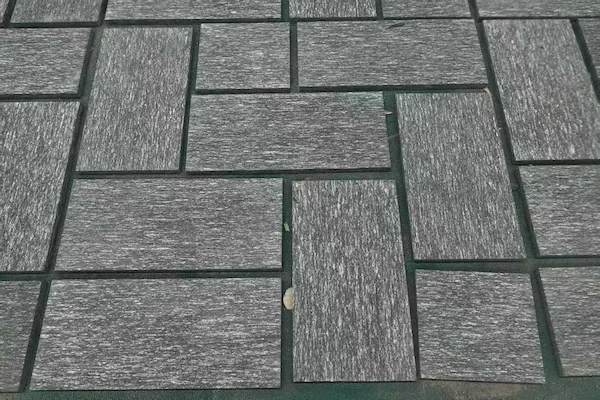 Night Snow Granite tiles arranged for dry-lay review in a supplied workshop image