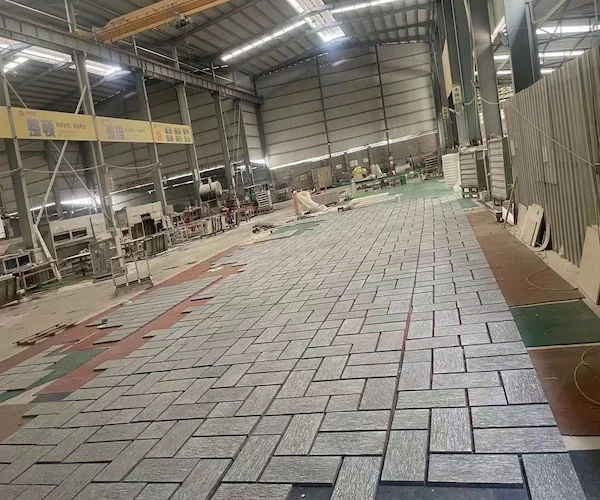 Night Snow Granite wall-cladding panels arranged for dry-lay review in a supplied factory image