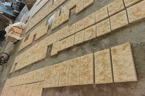 Supplied reference of multiple beige Rock Face Limestone pieces showing varied split-texture faces