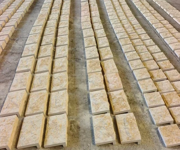 Supplied reference of beige Rock Face Limestone pieces arranged in rows for tonal-layout review