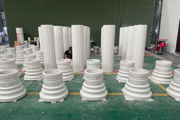 Grouped Sivec White Marble fluted shafts, bases and capitals on a factory floor