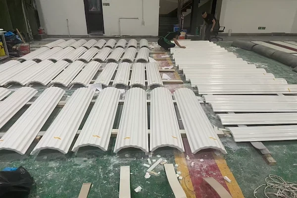 Curved Sivec White Marble fluted shaft pieces dry-laid beside flat stone panels