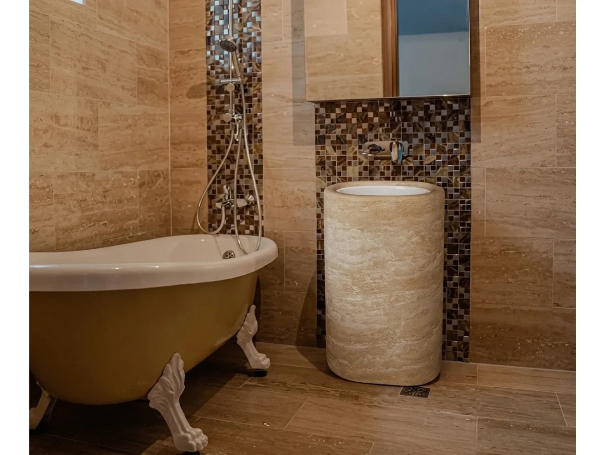 3D visualization of a round travertine pedestal vanity in a wabi-sabi bathroom concept