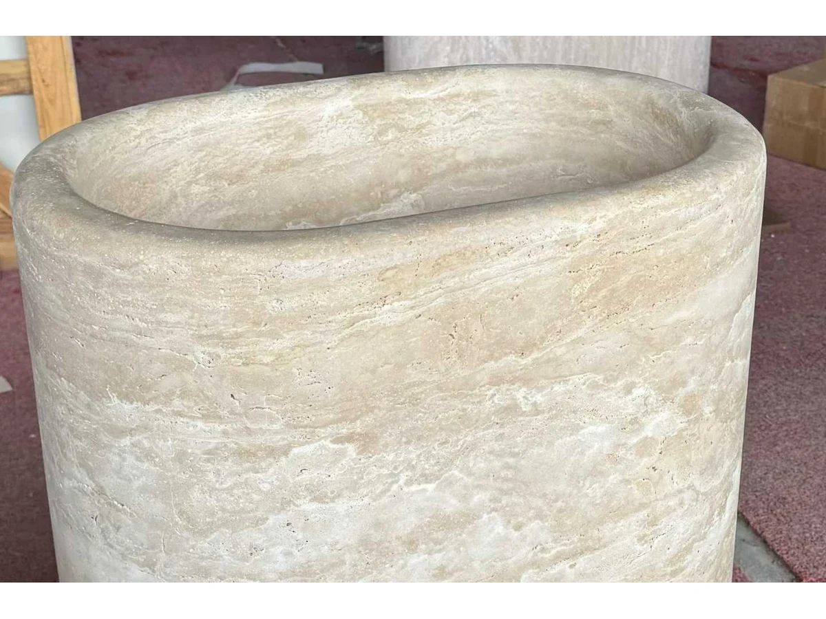 Beige travertine block prepared during round pedestal vanity fabrication