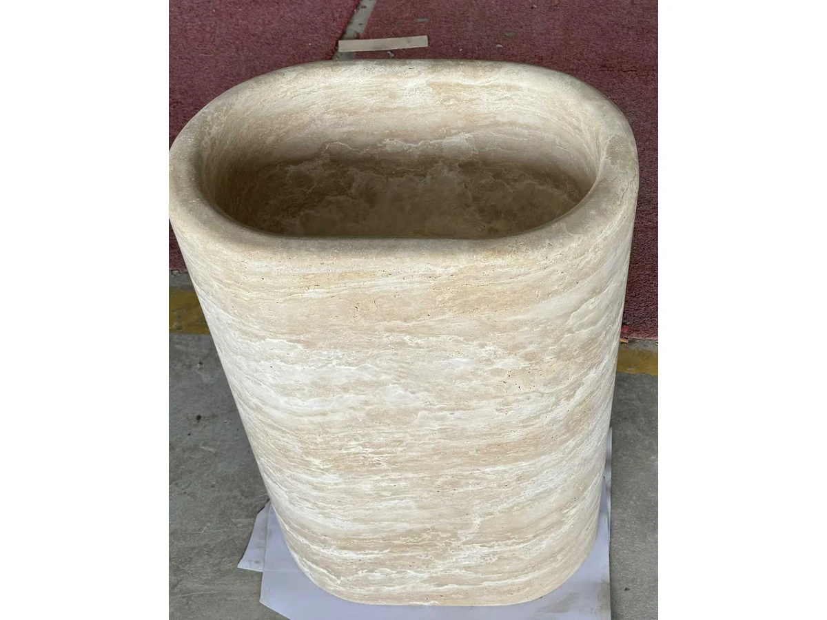 Beige travertine pedestal vanity surface reviewed during final quality inspection