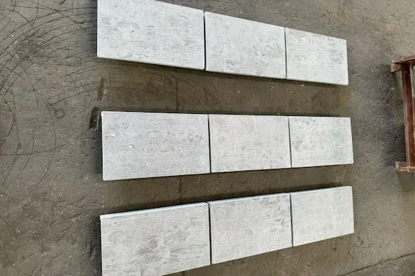 Tumbled Grey Limestone Pool Coping loose grey limestone coping pieces arranged for supplied layout review