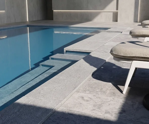 Tumbled Grey Limestone Pool Coping shown beside a pool edge in a supplied application reference image