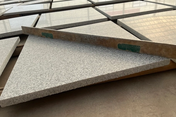 White Granite tile panels during surface-flatness inspection in a supplied factory image