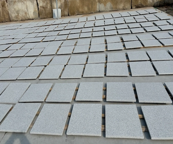 White Granite tiles arranged for layout color-matching in a supplied factory review area
