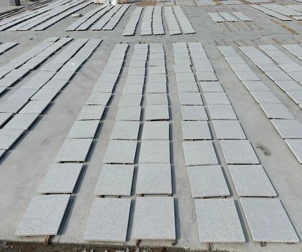 White Granite wall-cladding panels arranged for inspection in a supplied factory reference