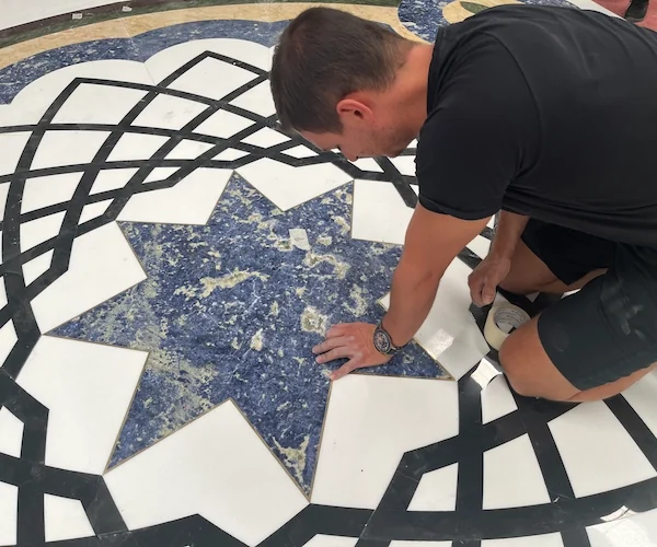 White Marble Waterjet Medallion with Blue Accents shown in a supplied joint review reference image