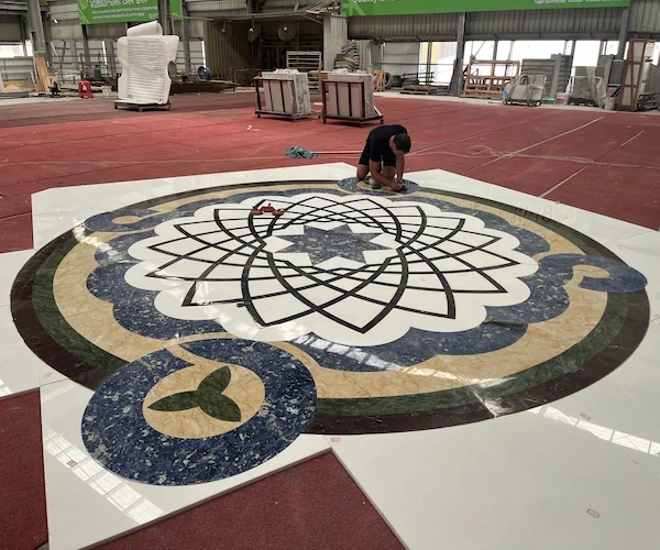 White Marble Waterjet Medallion with Blue Accents shown in a supplied factory dry-lay layout reference image