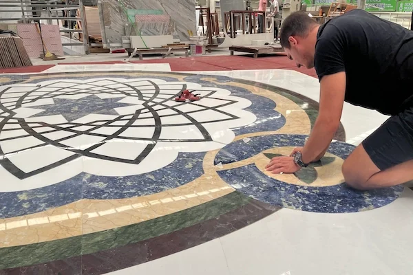 White Marble Waterjet Medallion with Blue Accents shown in a supplied factory inspection reference image