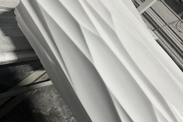 Close view of deep fluting carved into a White Marble column shaft component