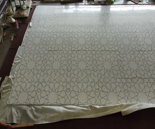 White Marble Waterjet Inlay with Brass Lines shown in a supplied joint review reference image