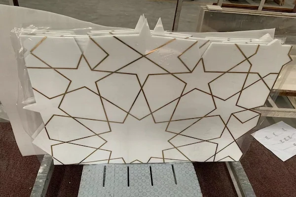 White Marble Waterjet Inlay with Brass Lines shown in a supplied factory inspection reference image