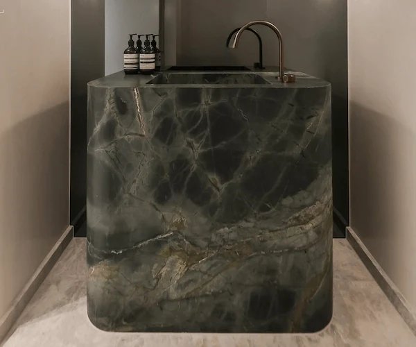 3D visualization of a Wizard of Oz Quartzite bathroom vanity concept with a curved stone front