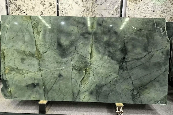 Polished Wizard of Oz Quartzite slab surface with olive-grey green colour and darker clouded inclusions