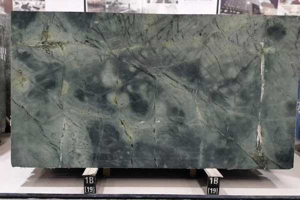 Close surface review of Wizard of Oz Quartzite with olive-green stone variation and darker mineral areas